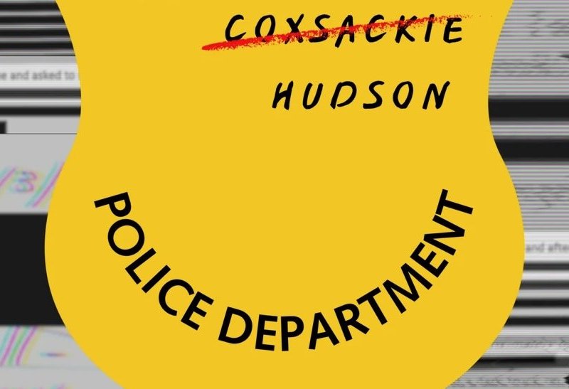 A police badge behind documents