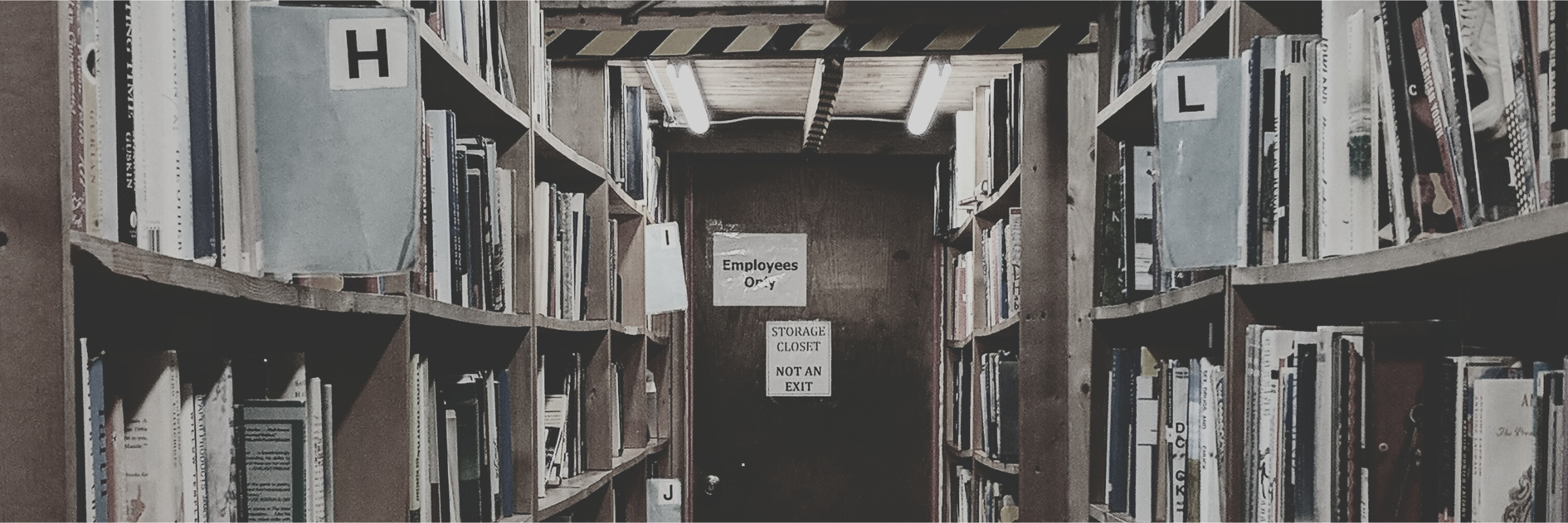 Bookshelves in a bookstore with a door that says Employees Only