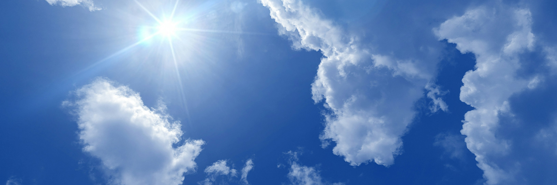 Blue sky with clouds and sun