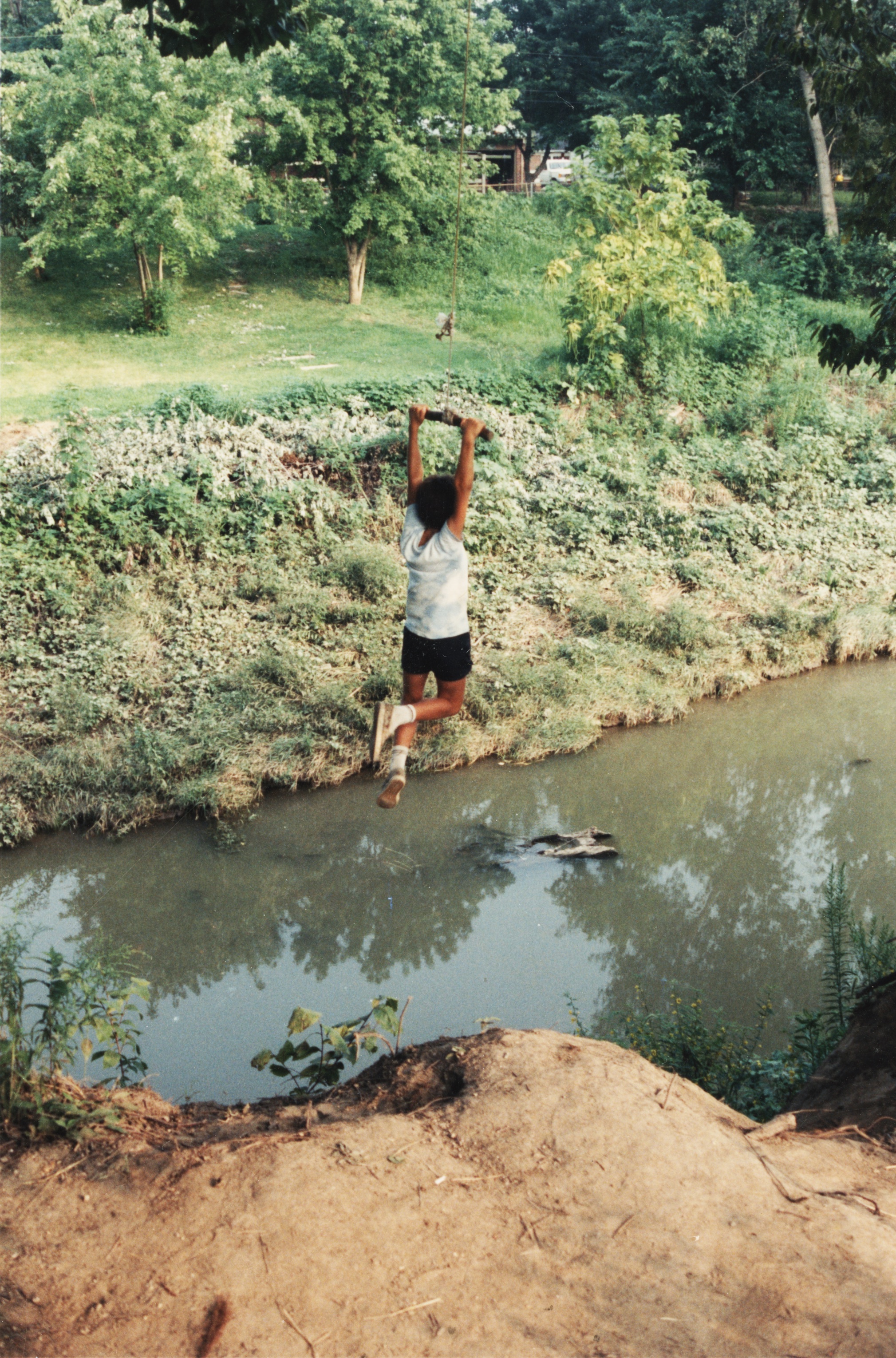 An undated photo from the 1980s, of a child swinging from a rope into Coldwater Creek. The photo is from a scrapbook kept by Sandy Delcoure, who lived on Willow Creek in Florissant and donated the scrapbook to the Kay Drey Mallinckrodt Collection. Only one of the photographs from the scrapbook includes any information, which read: “Willow Creek children on Cold Water [sic] Creek. We can’t keep the children away from the creek. The only alternative is to get it cleaned up.” (State Historical Society of Missouri, Kay Drey Mallinckrodt Collection, 1943-2006.)