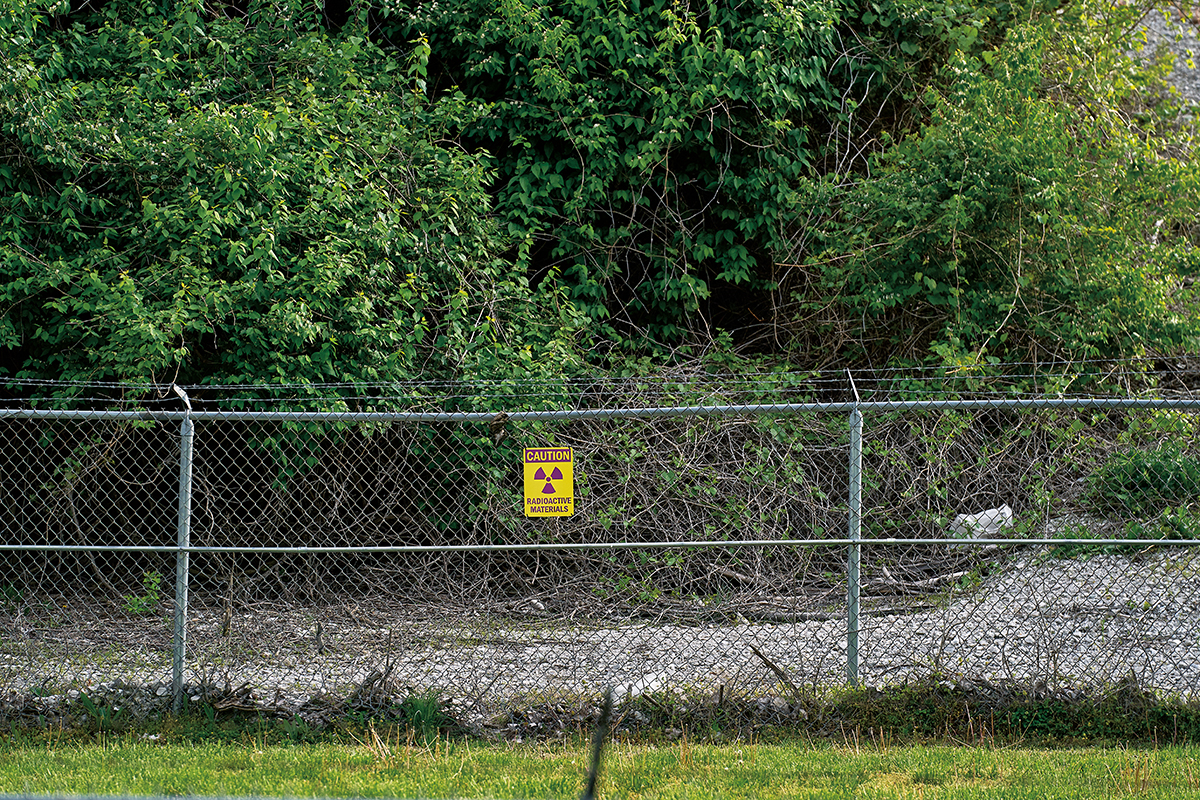 A sign warns of radioactive material at the West Lake Landfill. Thousands of tons of nuclear waste from the Manhattan Project were dumped there in the 1970s. (Theo Welling/Riverfront Times)