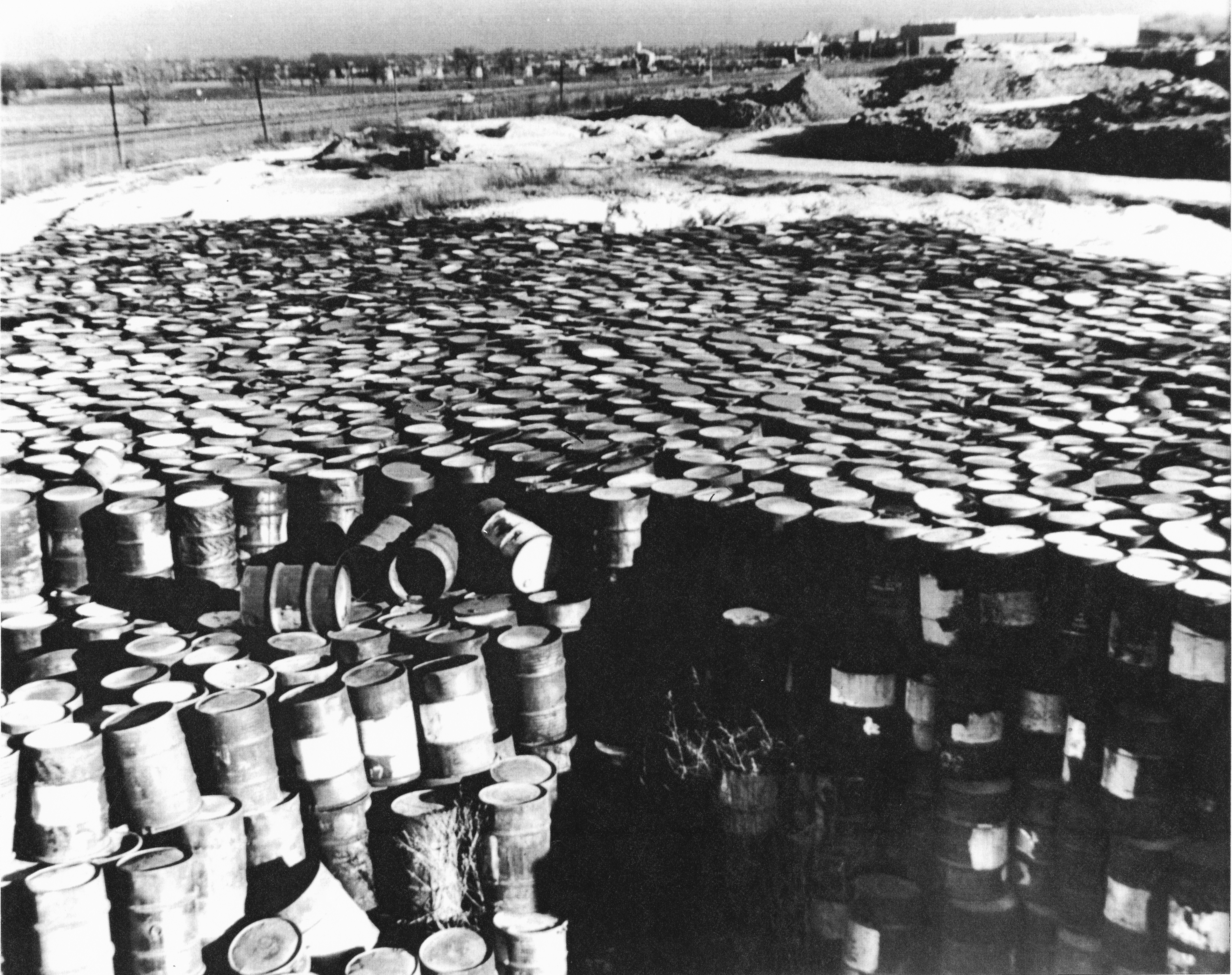 A photo taken in 1960 of deteriorating steel drums containing radioactive residues near Coldwater Creek, by the Mallinckrodt-St. Louis Sites Task Force Working Group. (State Historical Society of Missouri, Kay Drey Mallinckrodt Collection, 1943-2006.)