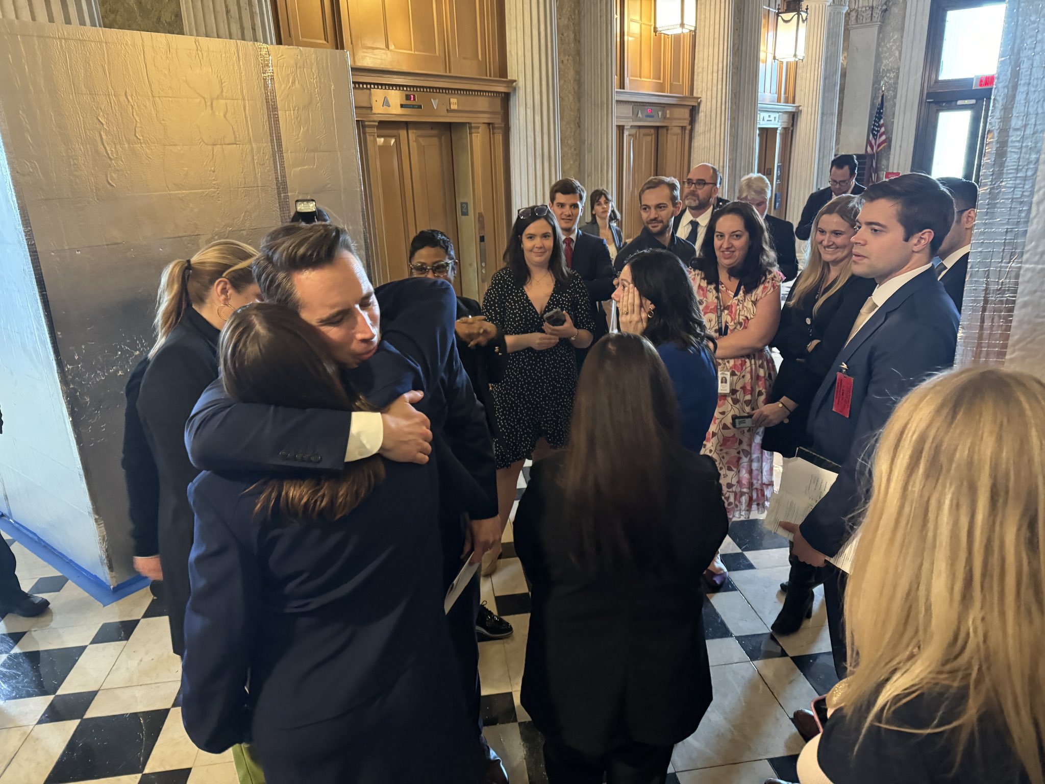 U.S. Sen. Josh Hawley, a Republican from Missouri, hugs radiation compensation fund supporters after a Senate vote to expand the program on March 7. (Alan He / CBS News)