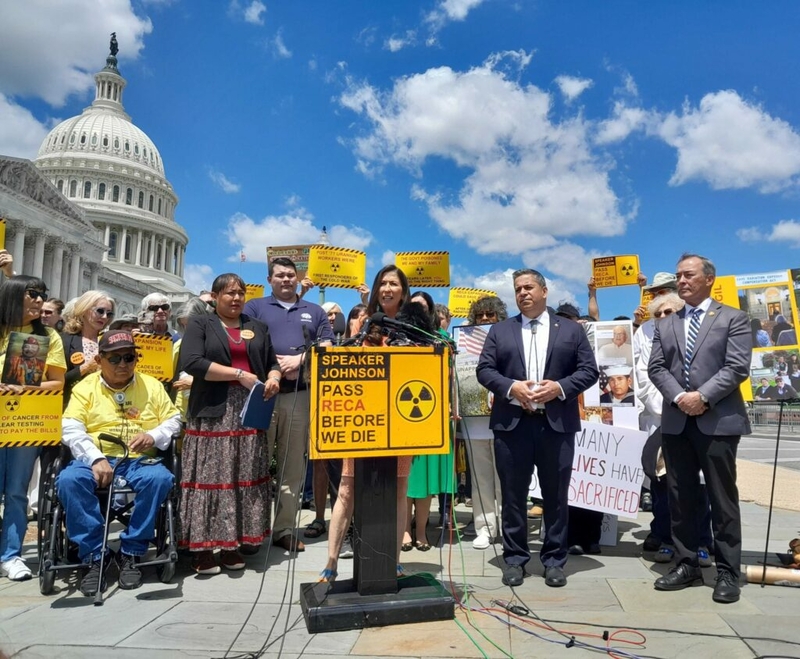 New Mexico Democrats Rep. Teresa Leger Fernandez, at the lectern, and Sen. Ben Ray Luján, and Guam’s Republican House delegate, James Moylan, along with advocates, on May 16, 2024, urged House Speaker Mike Johnson to call a vote to extend the Radiation Exposure Compensation Fund. The fund expires in early June (Ashley Murray/States Newsroom).